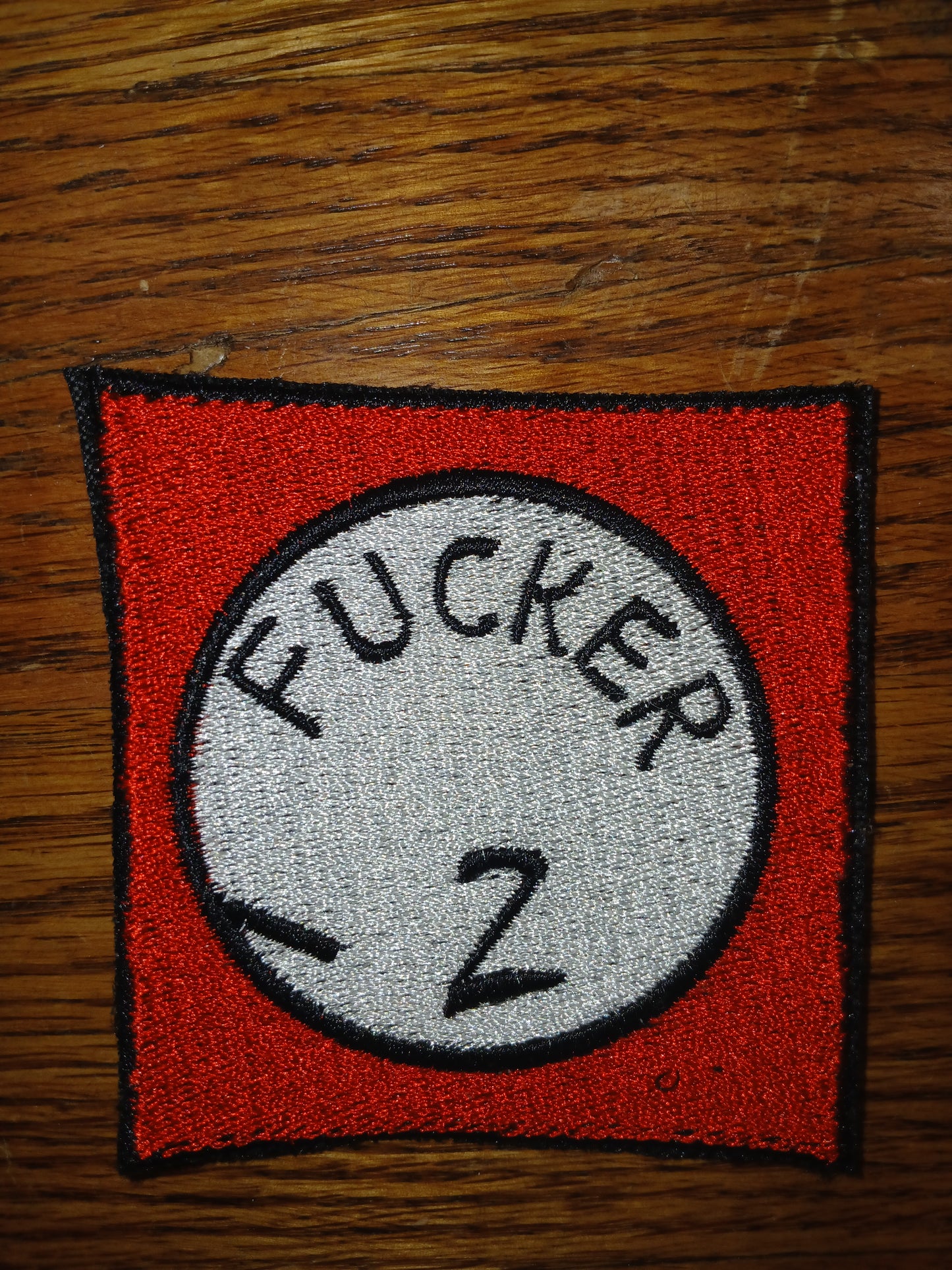 Patch with text "Fucker 2" on a red background