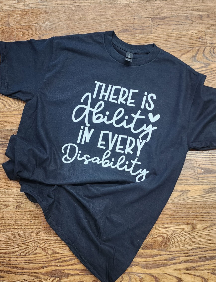 Navy blue t-shirt with white text There is Ability in every Disability