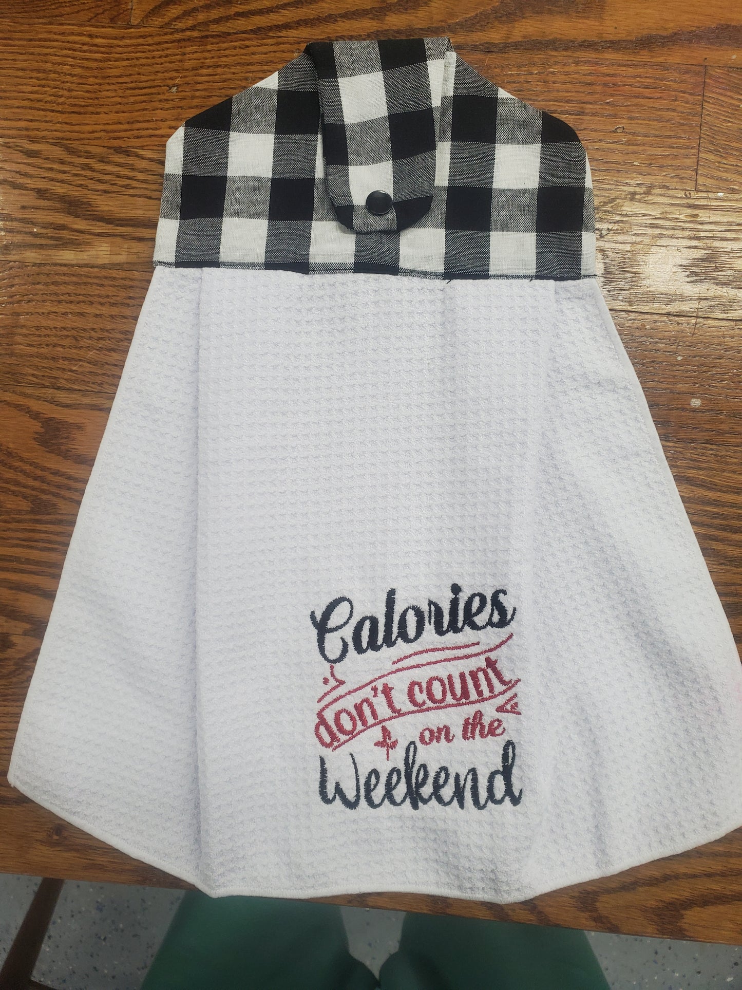 Attachable white towel with black and white checkered border and 'Calories don't count on the weekend' text 