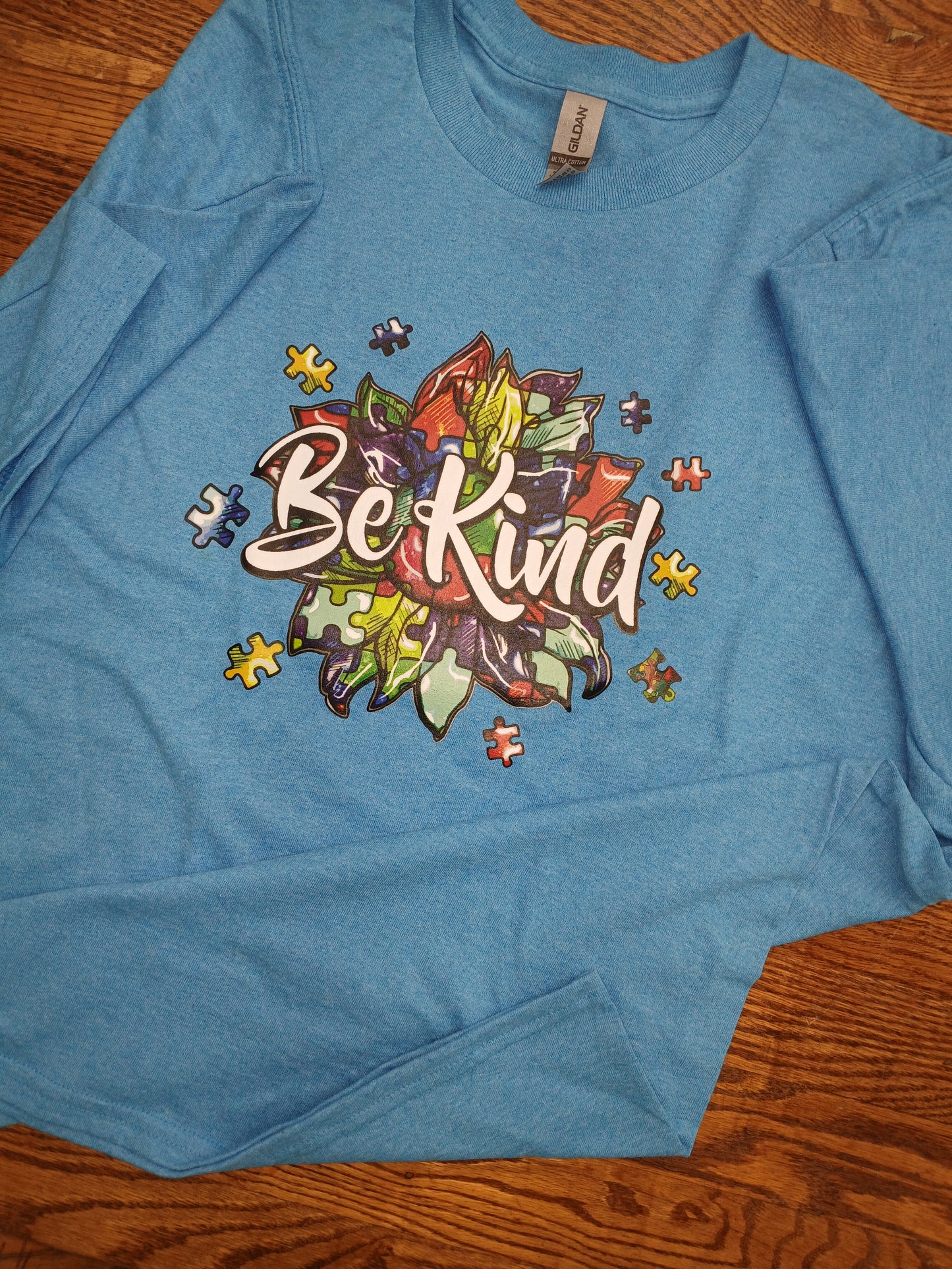 Blue t-shirt with 'Be Kind' design  supporting mental health awareness.