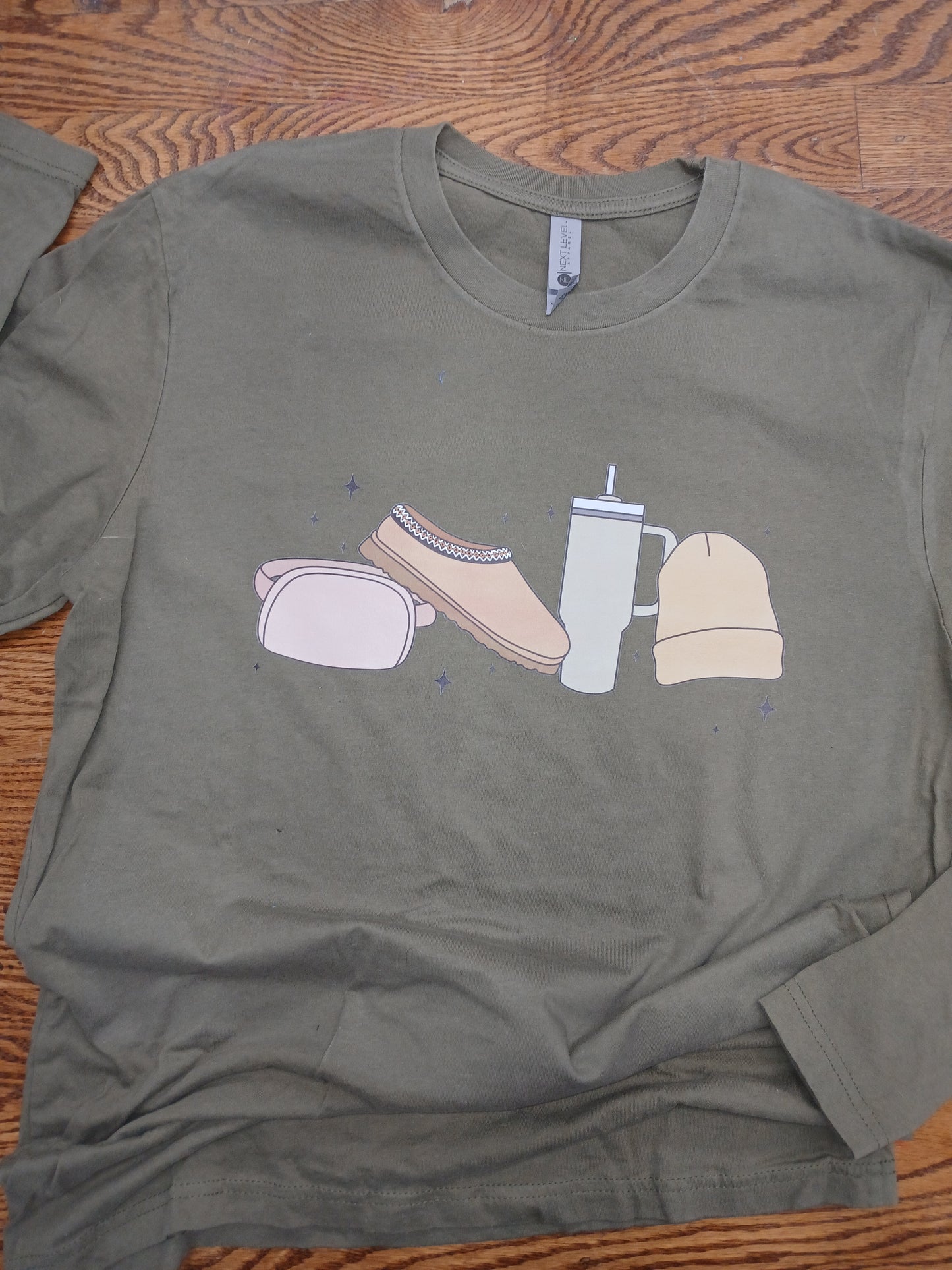 Green long sleeved t-shirt with a fun cozy fall graphic design. 