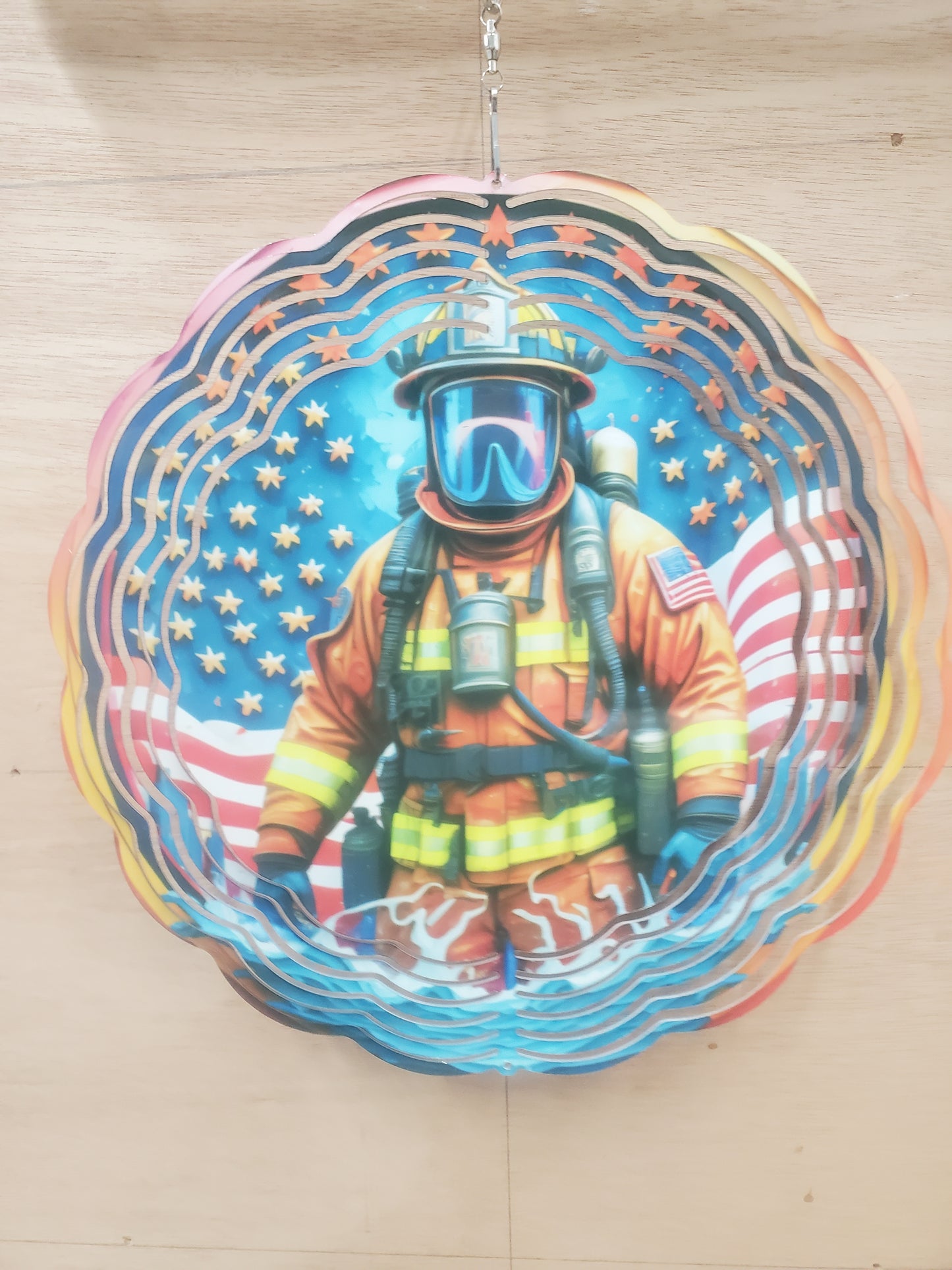 Firefighter in front of American flag 10 inch wind spinner 