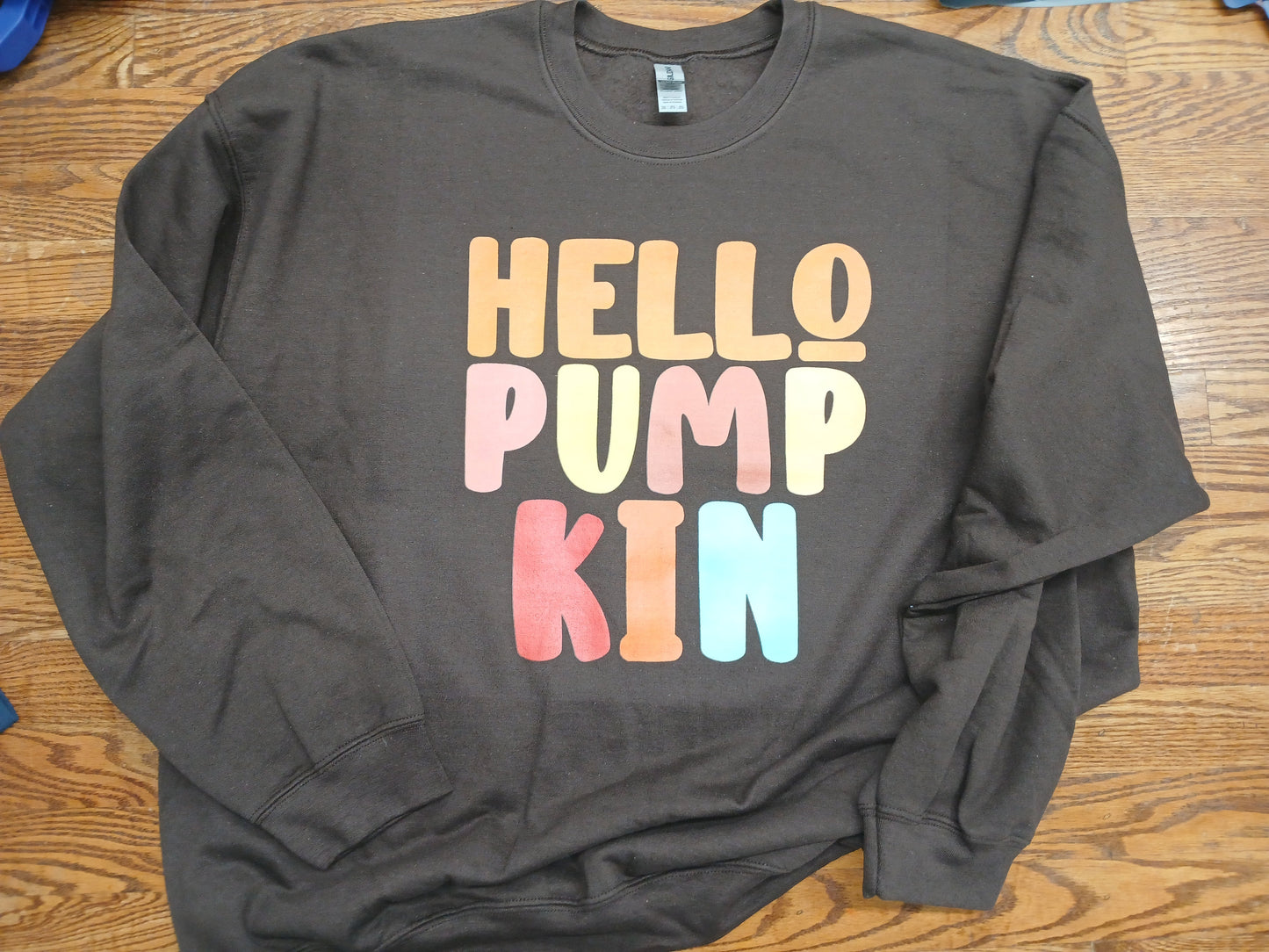 Cocoa Brown sweatshirt with 'HELLO PUMP KIN' text in colorful letters